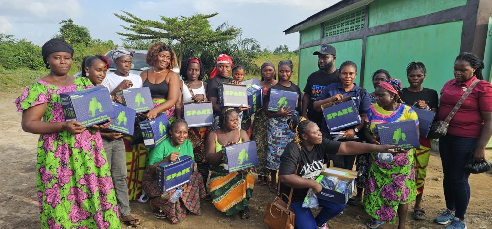 Community participants displaying solar home system kits during the SHS project